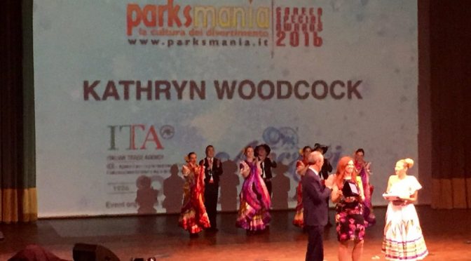long-distance shot of Dr. Woodcock receiving award at Parksmania event